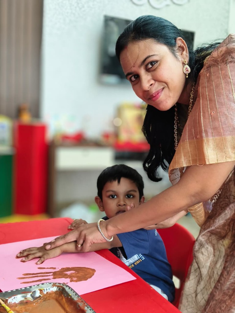 Handprint art activity with teacher